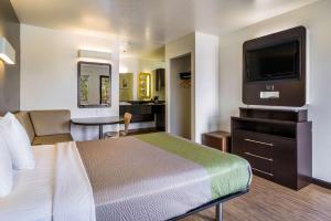 a hotel room with a bed and a flat screen tv at Studio 6-Fairfield, CA - Napa Valley in Fairfield