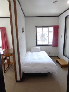 Postel nebo postele na pokoji v ubytování Hakuba Matata Lodge