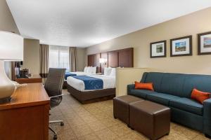 um quarto de hotel com uma cama e um sofá em Comfort Suites em Cedar Falls