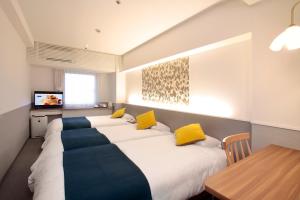 Tempat tidur dalam kamar di Hotel Plaza Osaka