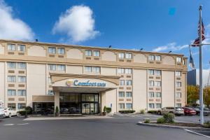 a hotel building with a car dealership in a parking lot at Comfort Inn Boston in Boston