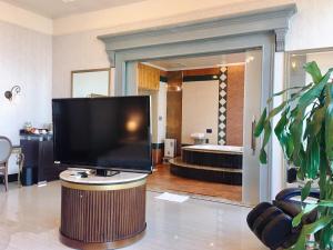 a television sitting on a table in a living room at Hi-Star View Hotel in Xizhi