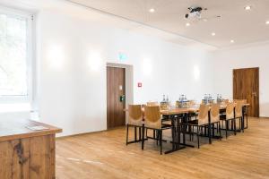 ein großes Esszimmer mit einem Tisch und Stühlen in der Unterkunft RiKu HOTEL Neu-Ulm in Neu Ulm