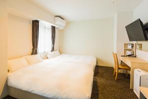 Hotel Ninestates Hakata tesisinde bir odada yatak veya yataklar