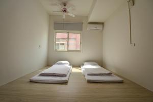 Una cama o camas en una habitación de Ta Li Wen B&B