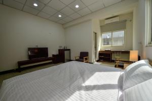Una cama o camas en una habitación de Ta Li Wen B&B