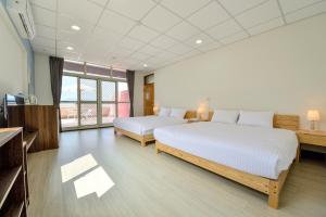 Una cama o camas en una habitación de Ta Li Wen B&B