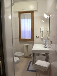 a white bathroom with a sink and a toilet at Residence i Morelli in Pietra Ligure