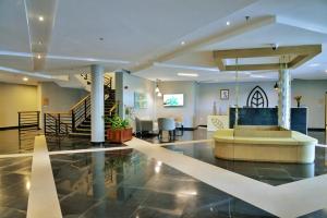 a lobby with a fountain in the middle of a building at EPIC Hotel & Suites in Nyagatare +37 photos