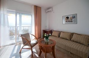 ein Wohnzimmer mit Sofa und Tisch in der Unterkunft Villa Tenžera in Herceg-Novi