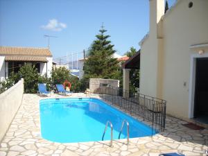 a swimming pool in the middle of a house at Villa Jasmine in Kalami