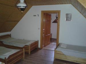 A bed or beds in a room at Nosztalgia Vendégház