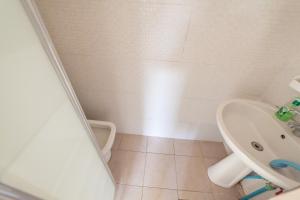 a bathroom with a toilet and a sink at Meile House in Rome