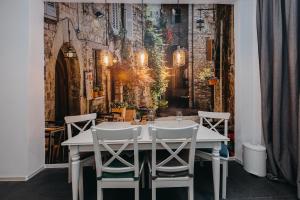 a dining room with a white table and chairs at ShortStayPoland Marszałkowska (B28) in Warsaw
