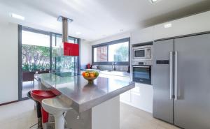 a kitchen with a counter with a bowl of fruit on it at Villa Claudia in L'Escala