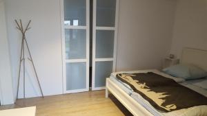 a bedroom with a bed and a large window at Haus am Prekkesee in Xanten