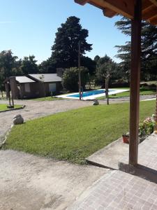 a yard with a swimming pool in the background at Lo de Charly in Sierra de la Ventana