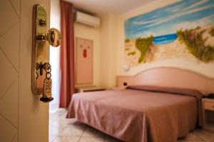 Postel nebo postele na pokoji v ubytování Hotel Sileoni