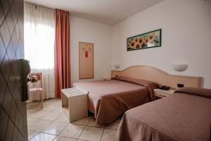 Postel nebo postele na pokoji v ubytování Hotel Sileoni