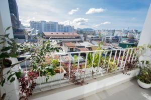 a balcony with a view of a city at ÉTÉ Dalat in Da Lat