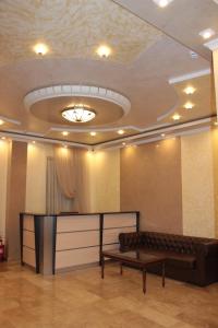 a room with a couch and a table and a ceiling at Hotel Ershov in Ishim