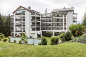 an apartment building with a garden in front of it at LAAX Homes - Val Mulin 8,2 - Scarpazza in Laax