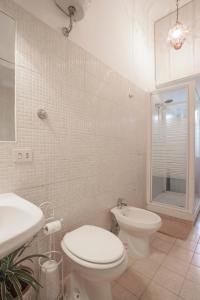 een witte badkamer met een toilet en een wastafel bij Sarah's B&B in Rome