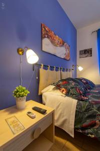 a bedroom with a bed and a table with a night stand at B & B San Cataldo in San Cataldo