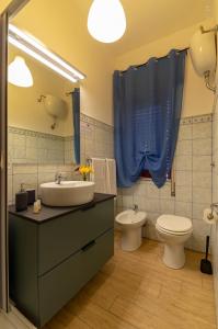 a bathroom with a sink and a toilet at B & B San Cataldo in San Cataldo +6 photos