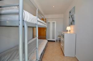 a bedroom with two bunk beds and a desk at Vista panorámica in Lloret de Mar