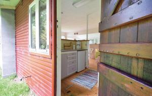 a kitchen with wood paneling on the side of a house at Granly in Ans