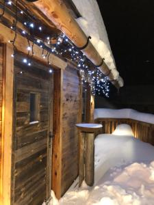 a cabin in the snow with lights on it at Lachtalchalet in Oberwölz Stadt