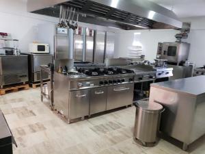 a kitchen with stainless steel appliances in a kitchen at Oasi Encantada - Beach Resort in Santa Cruz de Barahona