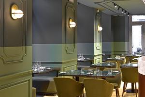 a restaurant with tables and chairs in a room at My Story Hotel Augusta in Lisbon