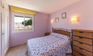 a bedroom with a bed and a window at Apartment Elena in L'Escala