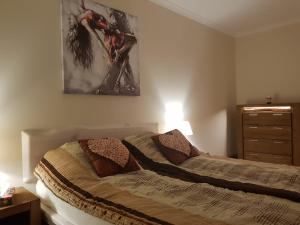 a bedroom with two twin beds and a dresser at Przytulny Zakątek in Piła