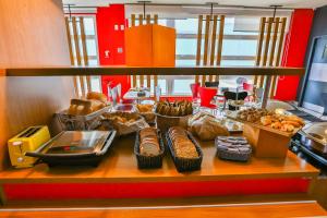 a counter filled with lots of different types of food at ibis Goiania in Goiânia
