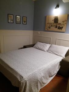 a bedroom with a bed with a white comforter at Casa Camilla in Viareggio