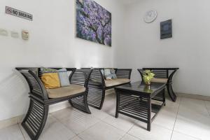 a group of chairs and a table in a room at Cozy Residence Muwardi in Jakarta