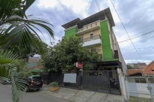 a car parked in front of a building at Cozy Residence Muwardi in Jakarta