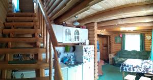 a kitchen and stairs in a log cabin at Teremok in Tatariv