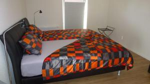 a bed with a checkered blanket on top of it at Fewo Ausblick in Hechthausen +1 photo
