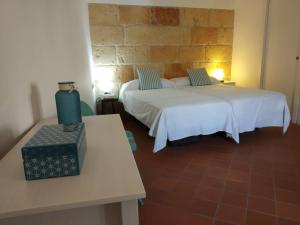 a room with two beds and a table and two tables at Andrones in Ciutadella