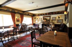
a living room filled with furniture and tables at The Colesbourne Inn in Colesbourne
