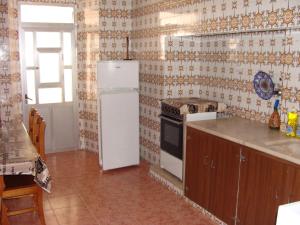 a kitchen with a refrigerator and a stove at Aguarela Tavira in Tavira