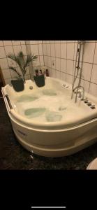a white bath tub sitting in a bathroom at Ferienparadies in Fürth