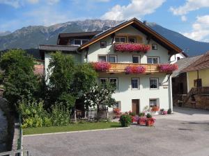 a large white building with flowers on it at Salvesenheim in Tarrenz