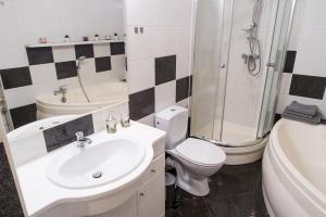 a bathroom with a sink and a toilet and a shower at APARTAMENT FOCUS in Gdynia +16 photos