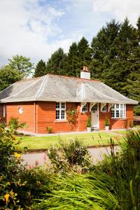 a red brick house with a gray roof at The Gardener's Cottage in Dunblane
