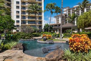a pool in the middle of a resort with buildings at Beach Villas at Ko Olina 5th floor Ocean View in Kapolei